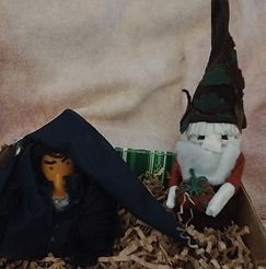 Women Gnome and Guy Gnome holding a pumpkins.