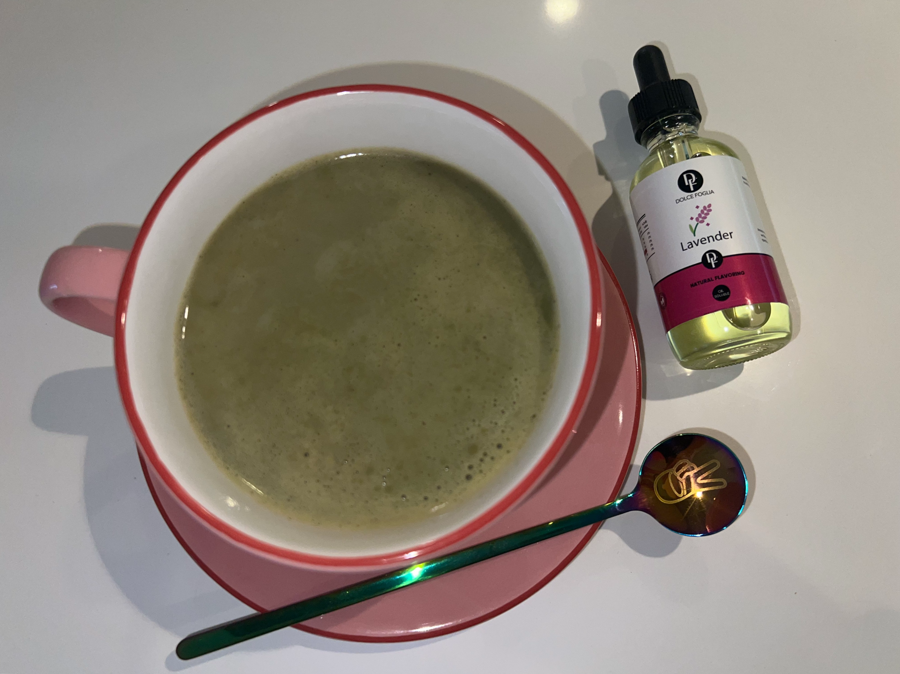 Matcha latte with Lavender on a plate with a teaspoon