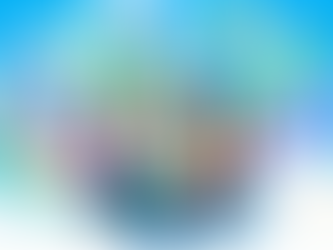 Meeting room with people sitting and standing around a round desk, putting jigsaw puzzle pieces together