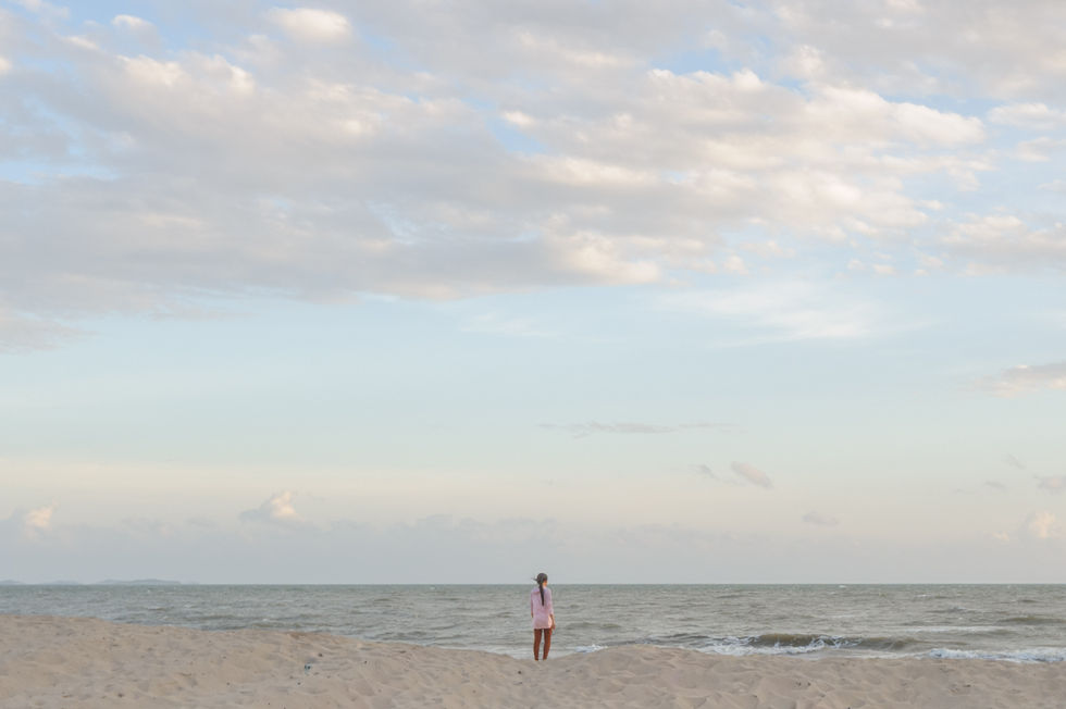 Young woman looking at ocean in Cambodia.