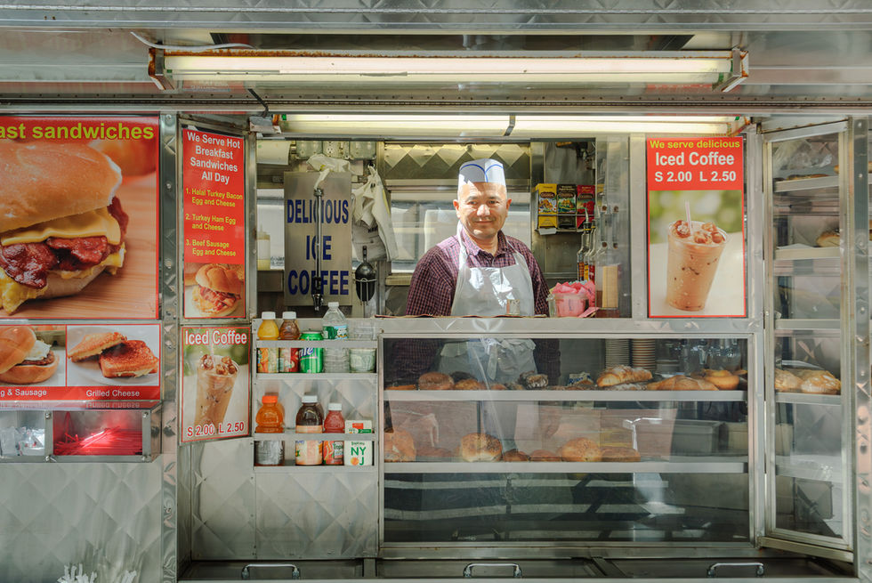 Street stall vendor smiles in New York, USA.
