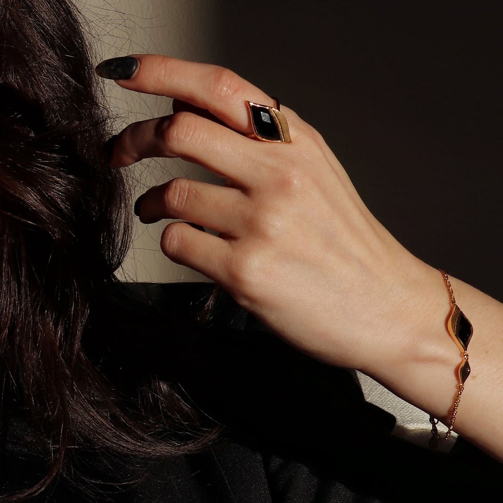 Thumbnail: Gold ring set with black onyx stone worn by model