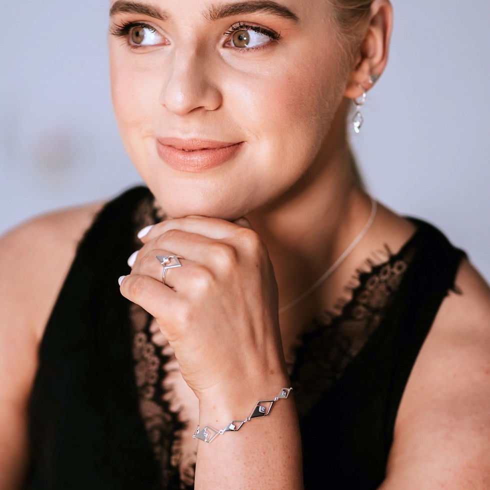 Thumbnail: Model wearing silver bracelet with five diamond shapes set with cubic zirconia.