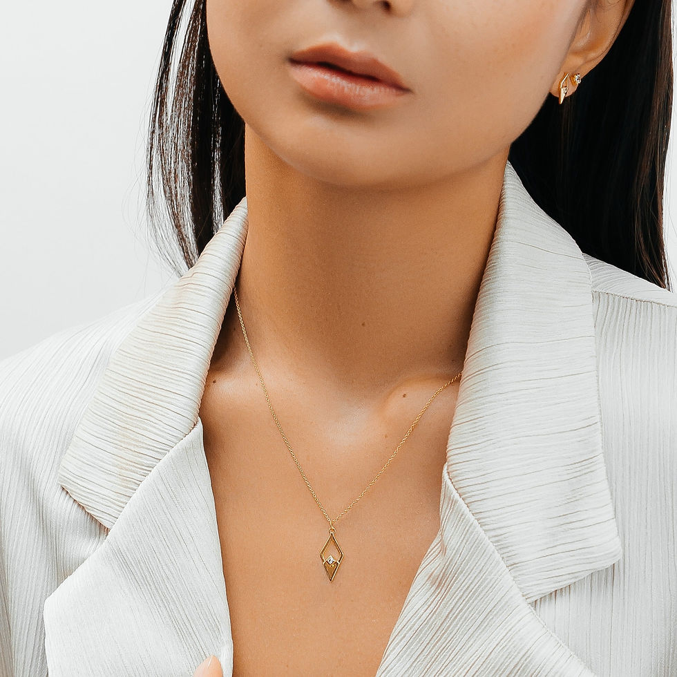 Thumbnail: Model wearing gold vermeil necklace chain with diamond shape pendant set with a single clear cubic zirconia