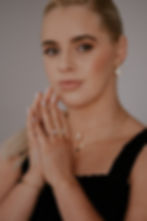 Gold ring with opal stone cut in the unique Lustre & Love shape, worn by model