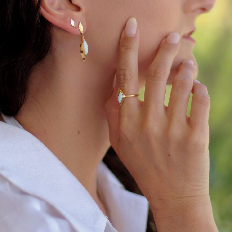 Thumbnail: Gold ring with opal stone cut in the unique Lustre & Love shape, worn by model