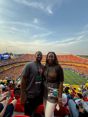 Terrell A. Turner and Lola Turner at the Colombia vs. Ghana World Cup match in Kansas City, surrounded by fans in the stadium.