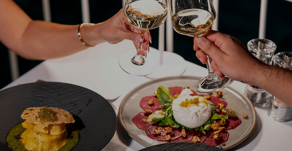 Couple toasting with wine over a dinner