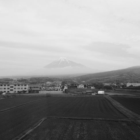 a black and white image of Mount Fuji shrouded in clouds