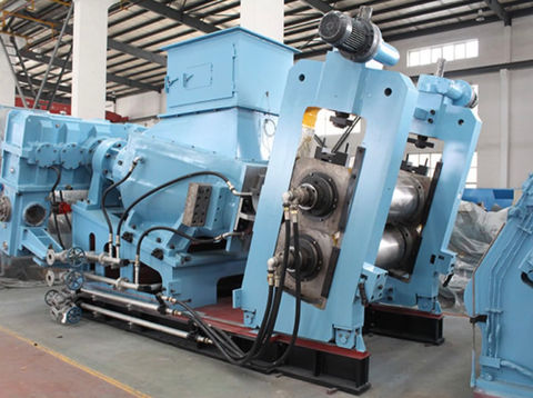 Roll mill - An image of a roll mill, a type of machinery used in the rubber and plastic industries for processing and refining materials. The machine consists of two counter-rotating cylindrical rolls that apply pressure and friction to mix, blend, or shape the material between them.