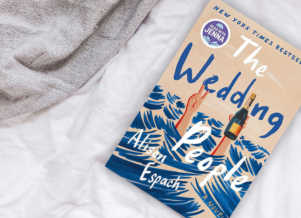 the wedding people book on a bed with a grey blanket