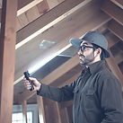 A home inspector in an attic