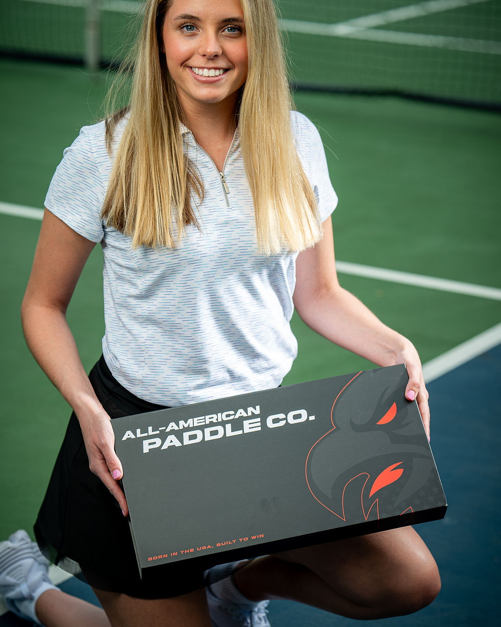 Girl holding All-American Paddle Co. box containing USA made pickleball paddle