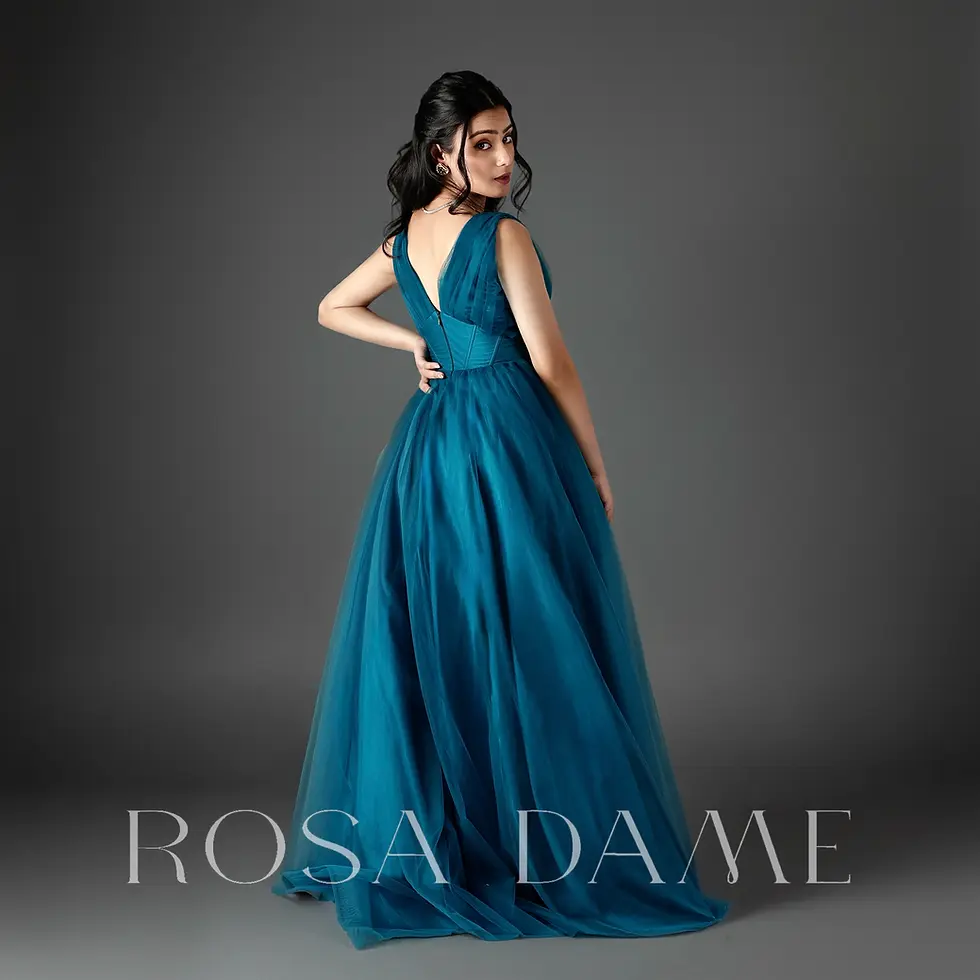 back view of teal draped tulle evening gown with structured waist and flowing skirt