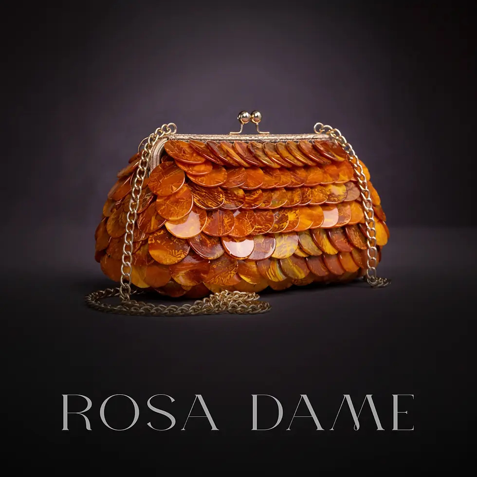Structured amber layered disc couture clutch with gold chain strap.