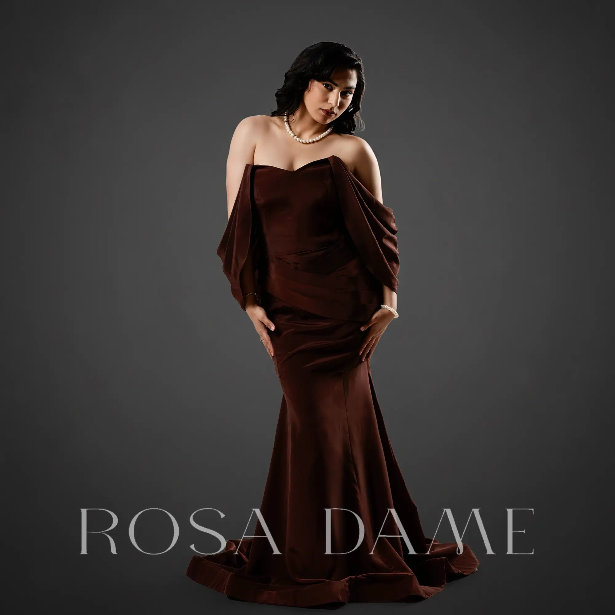 Front view of chocolate brown off shoulder corset mermaid gown