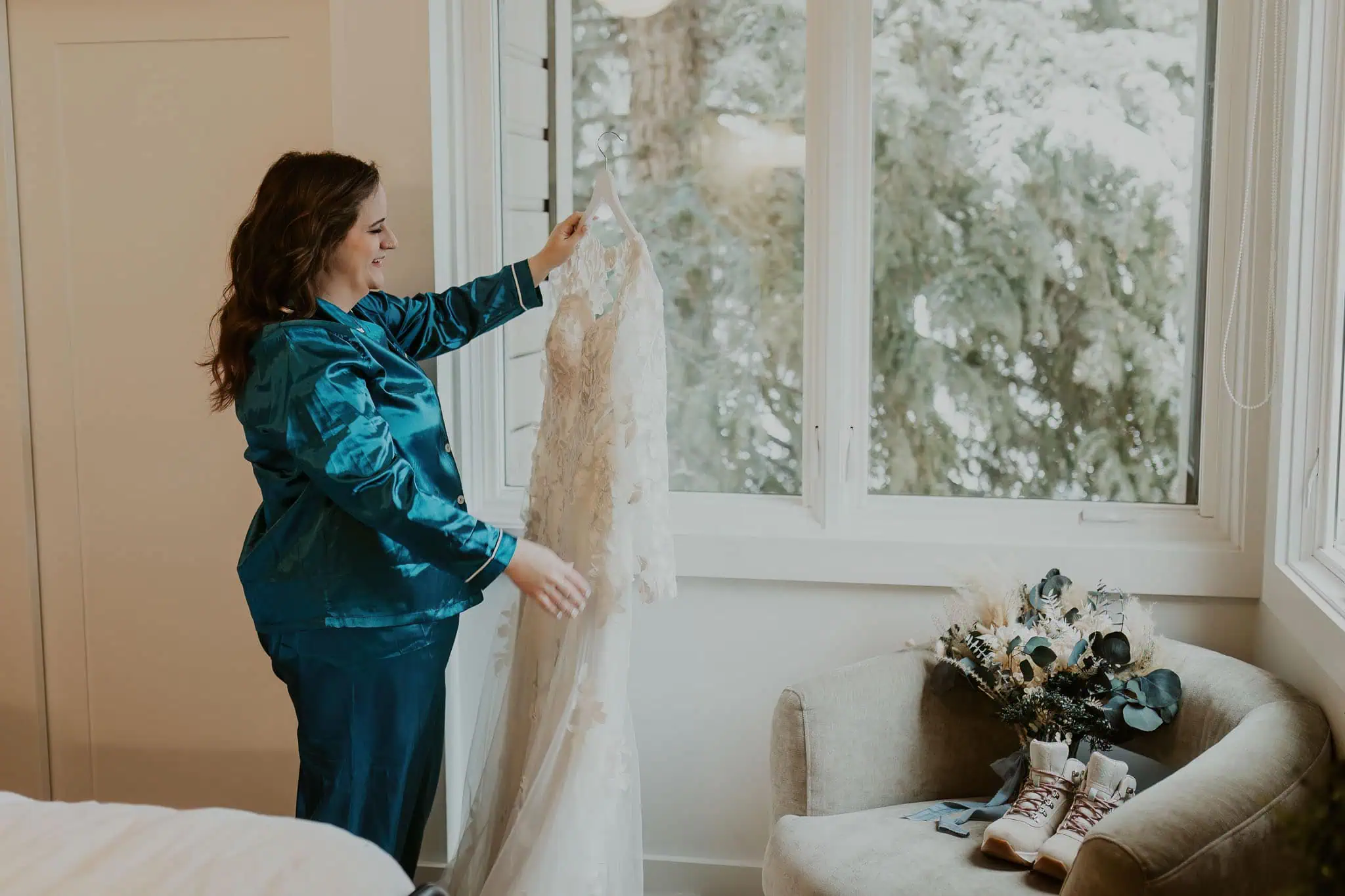a bride holding her dress on the hanger