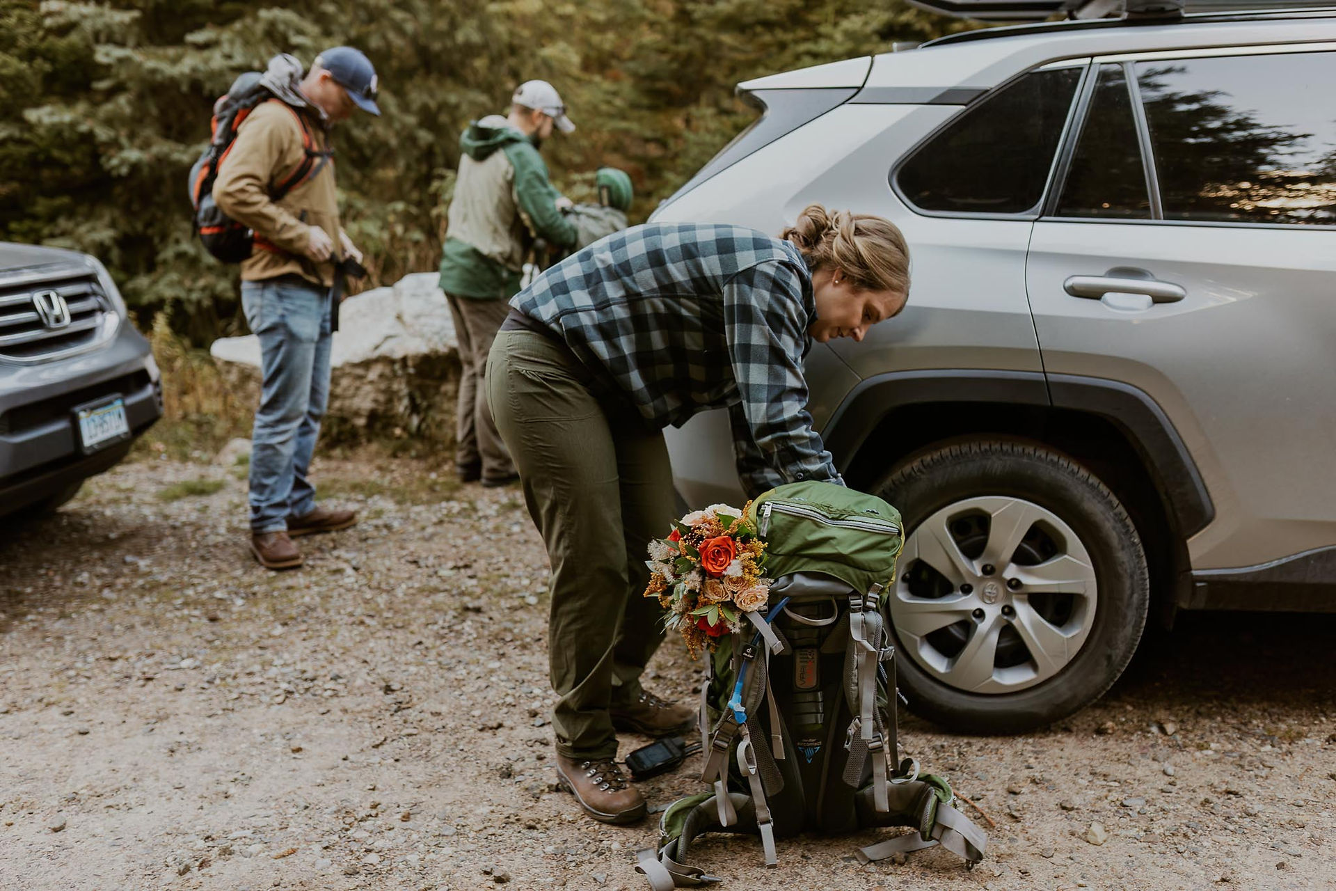 bride packing her hiking bag for her  elopement hiking