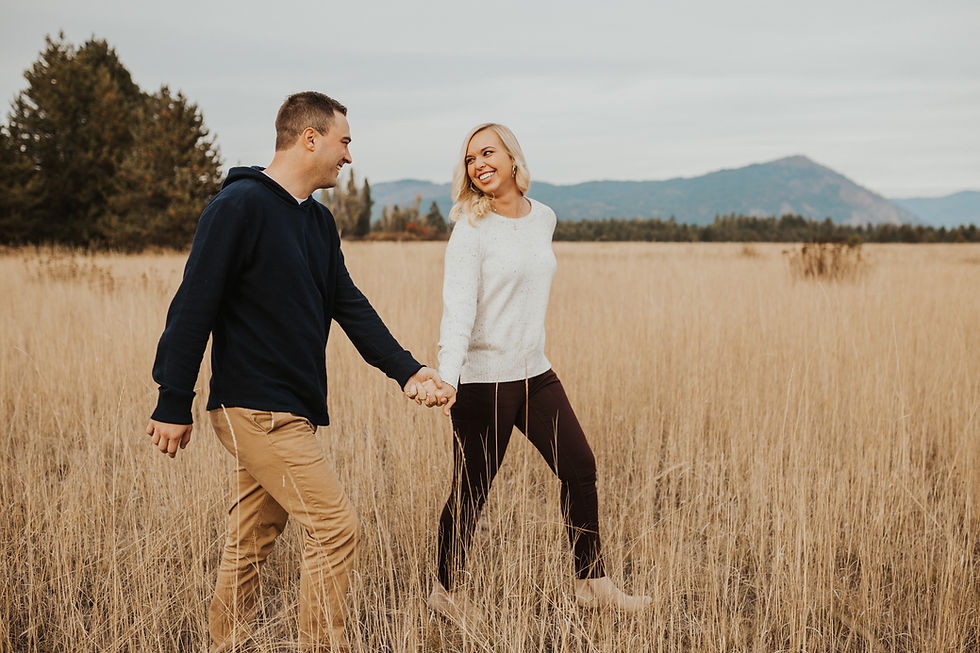 engagement session in north idaho with mountains, fields, and lake