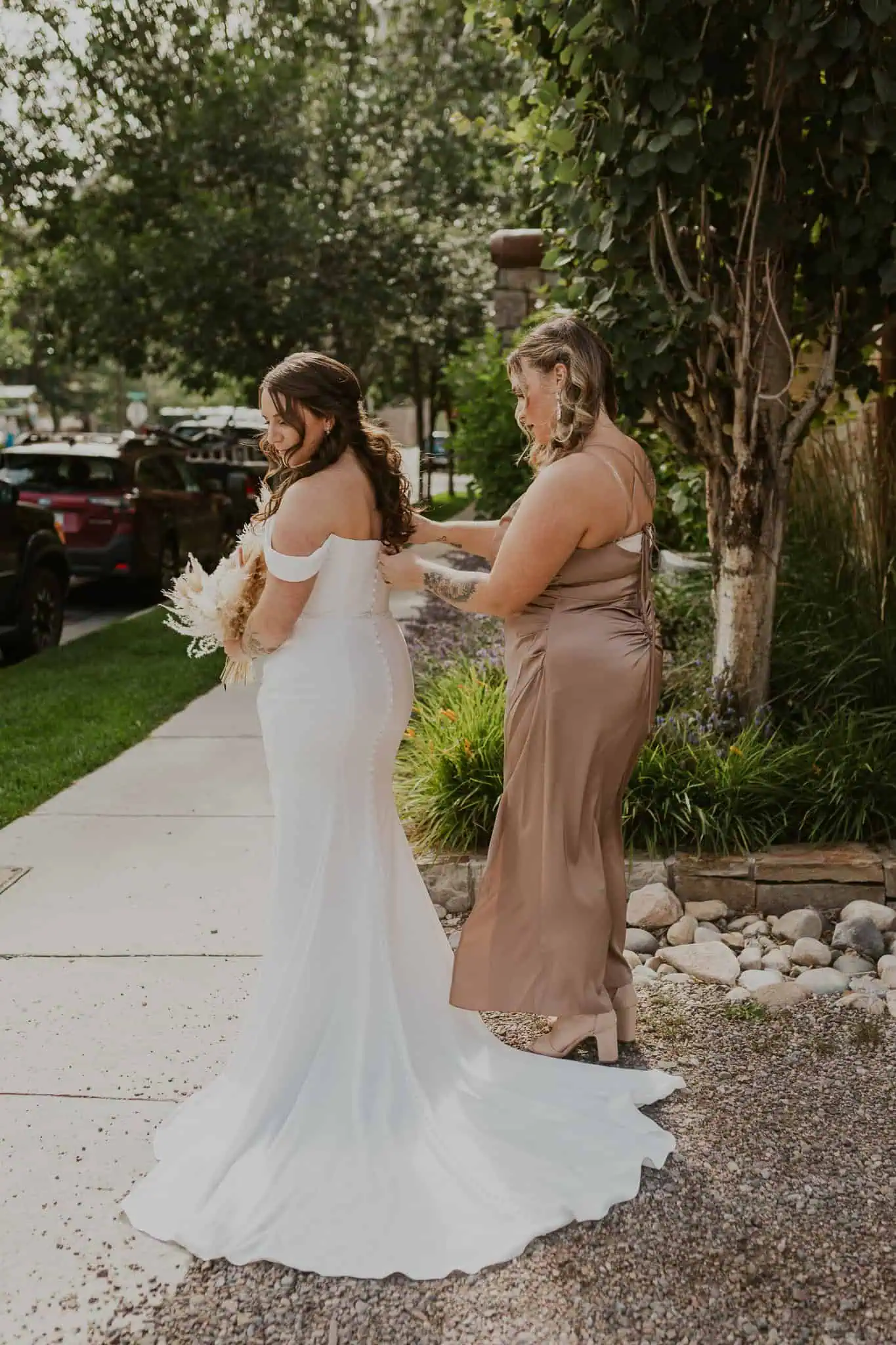 bride getting her dress zipped up