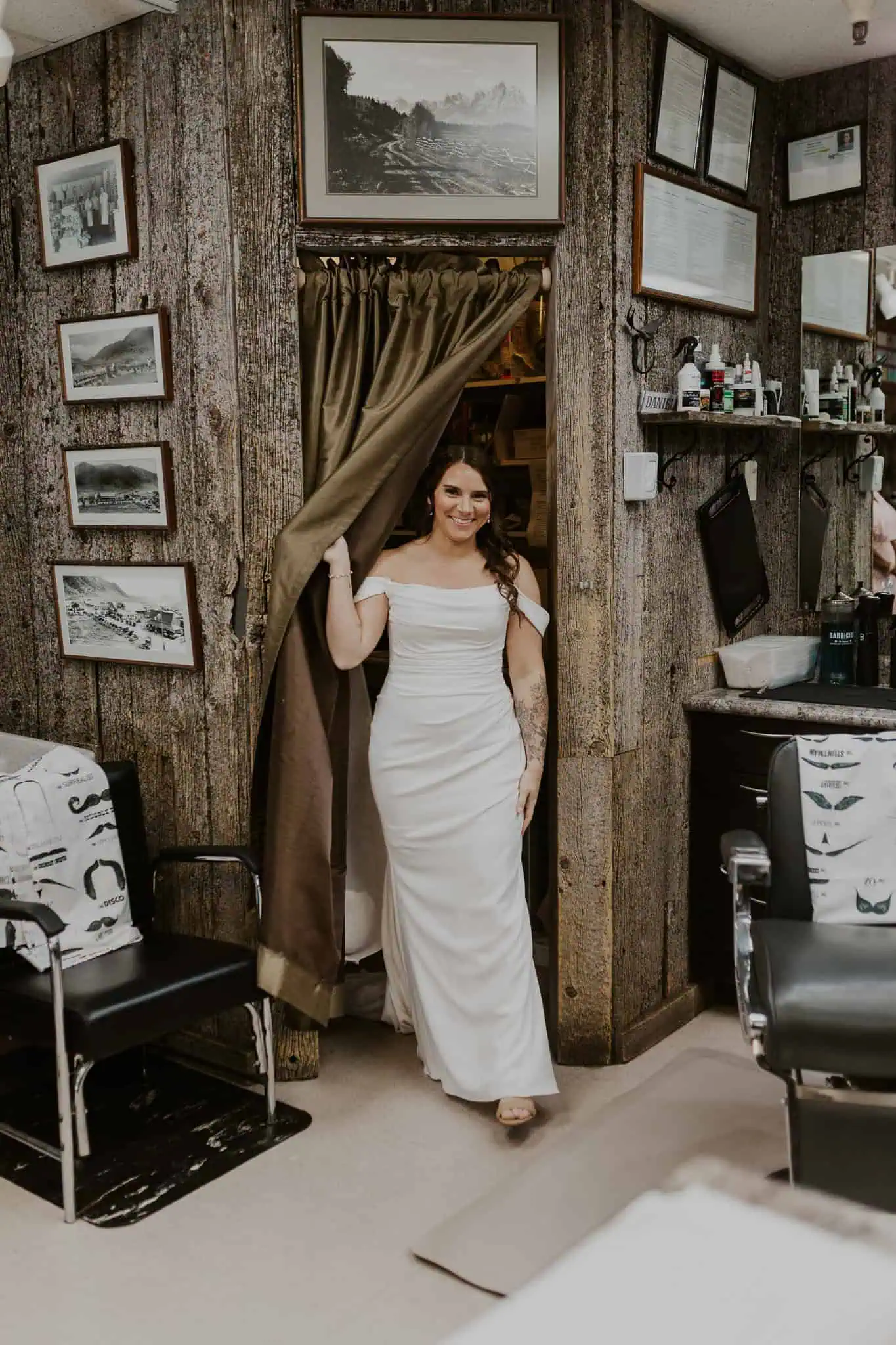 a bride smiling after getting in her dress
