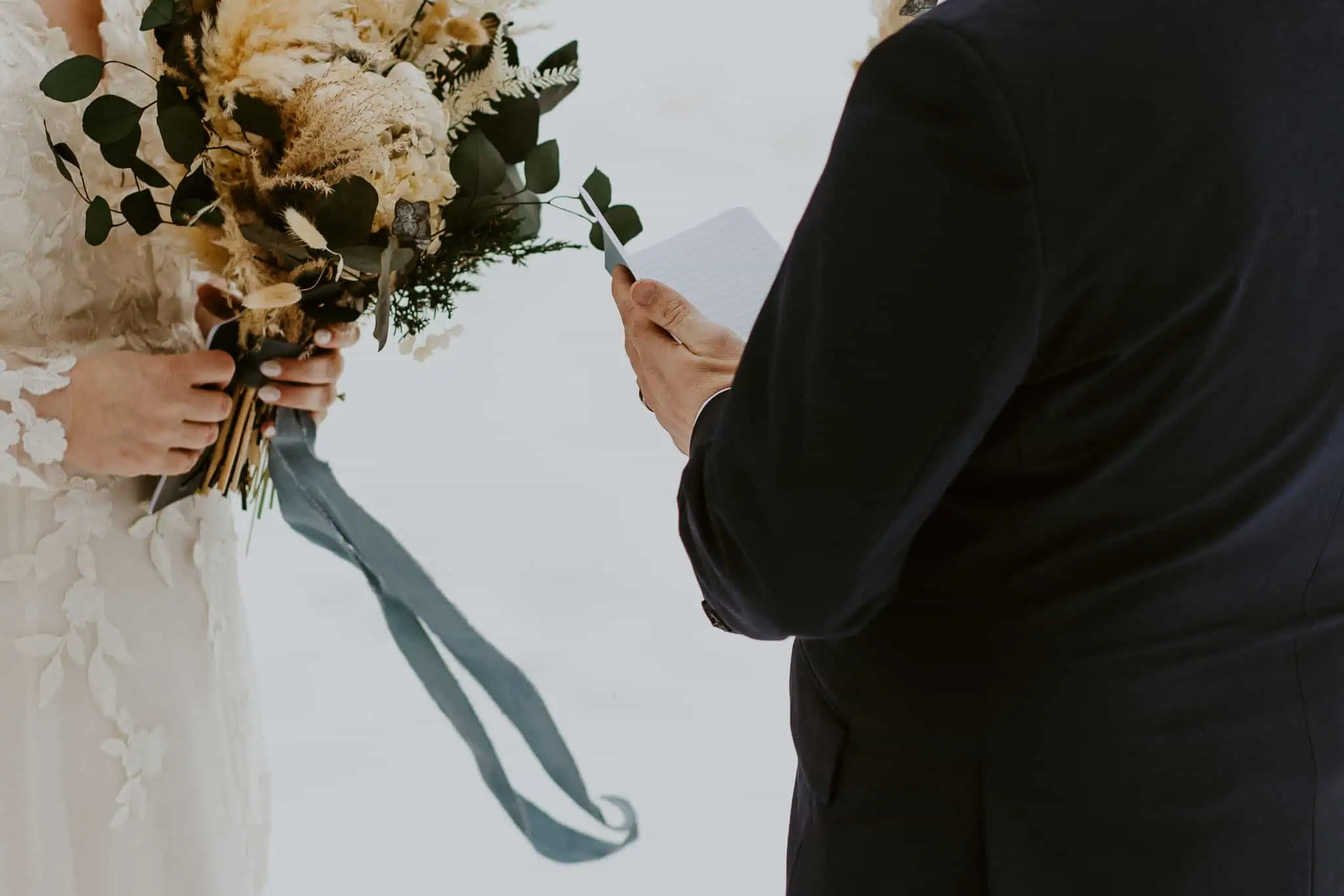 groom reading his vows in front of snowy mountains in idaho