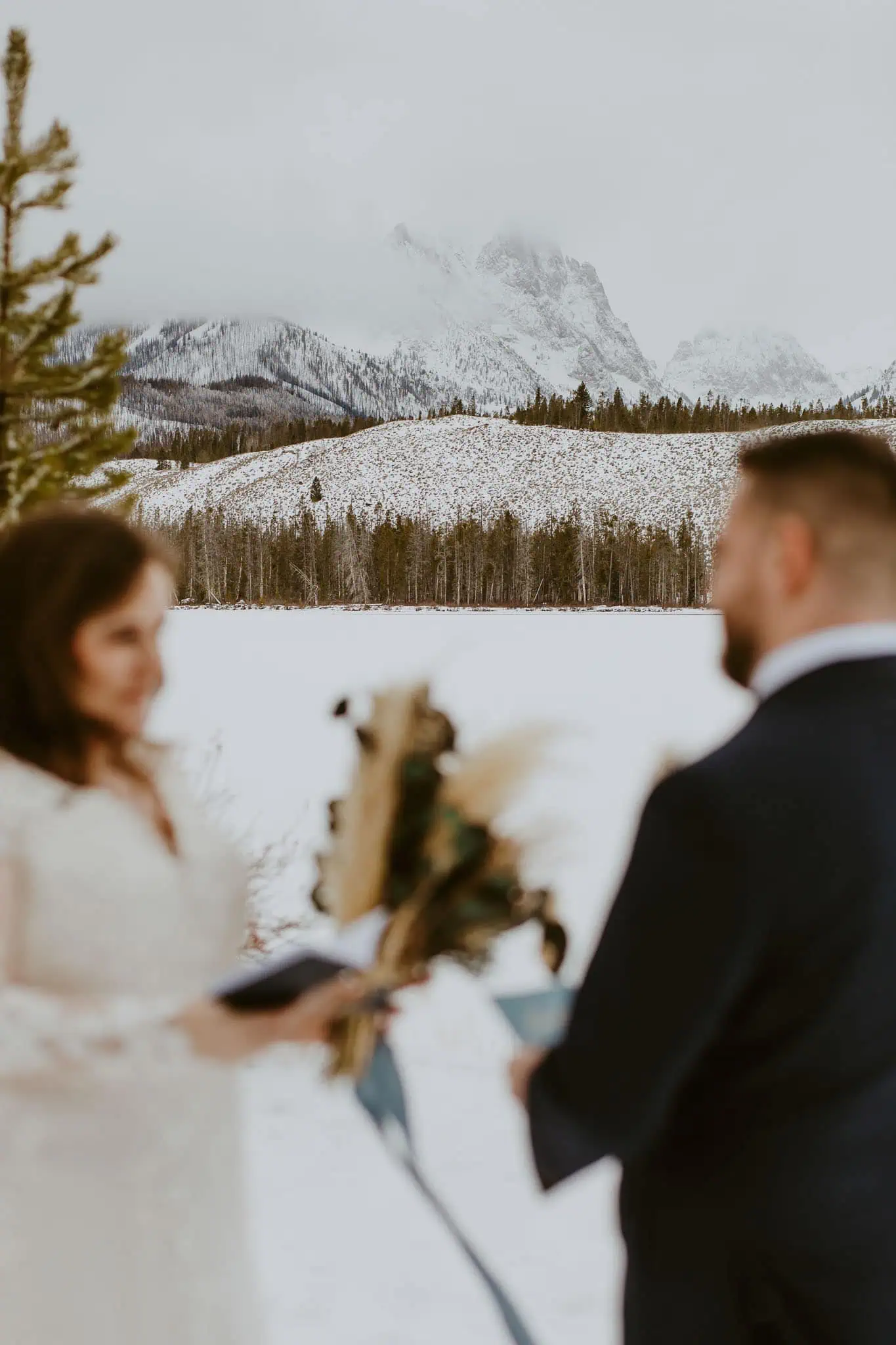 a bride reading her vows to her groom in the snow