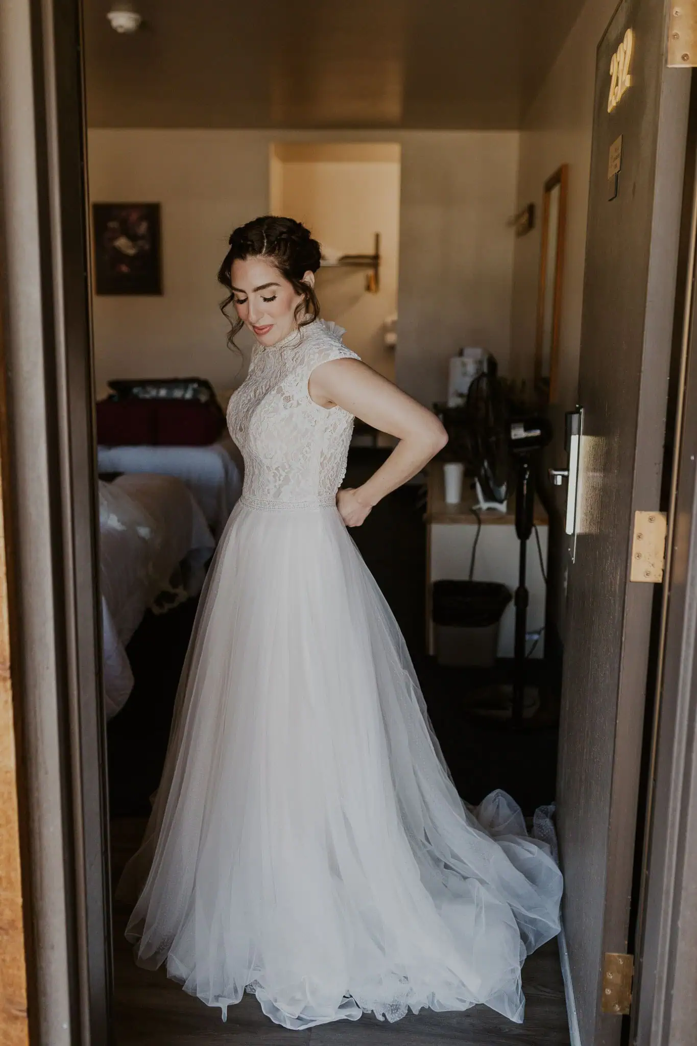 bride buttoning up her dress