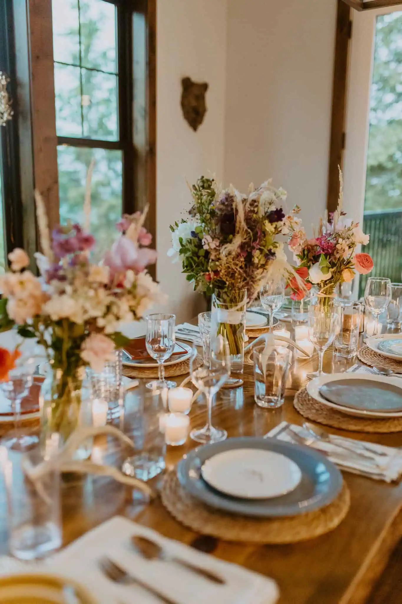 a dinner table with flowers and blue plates