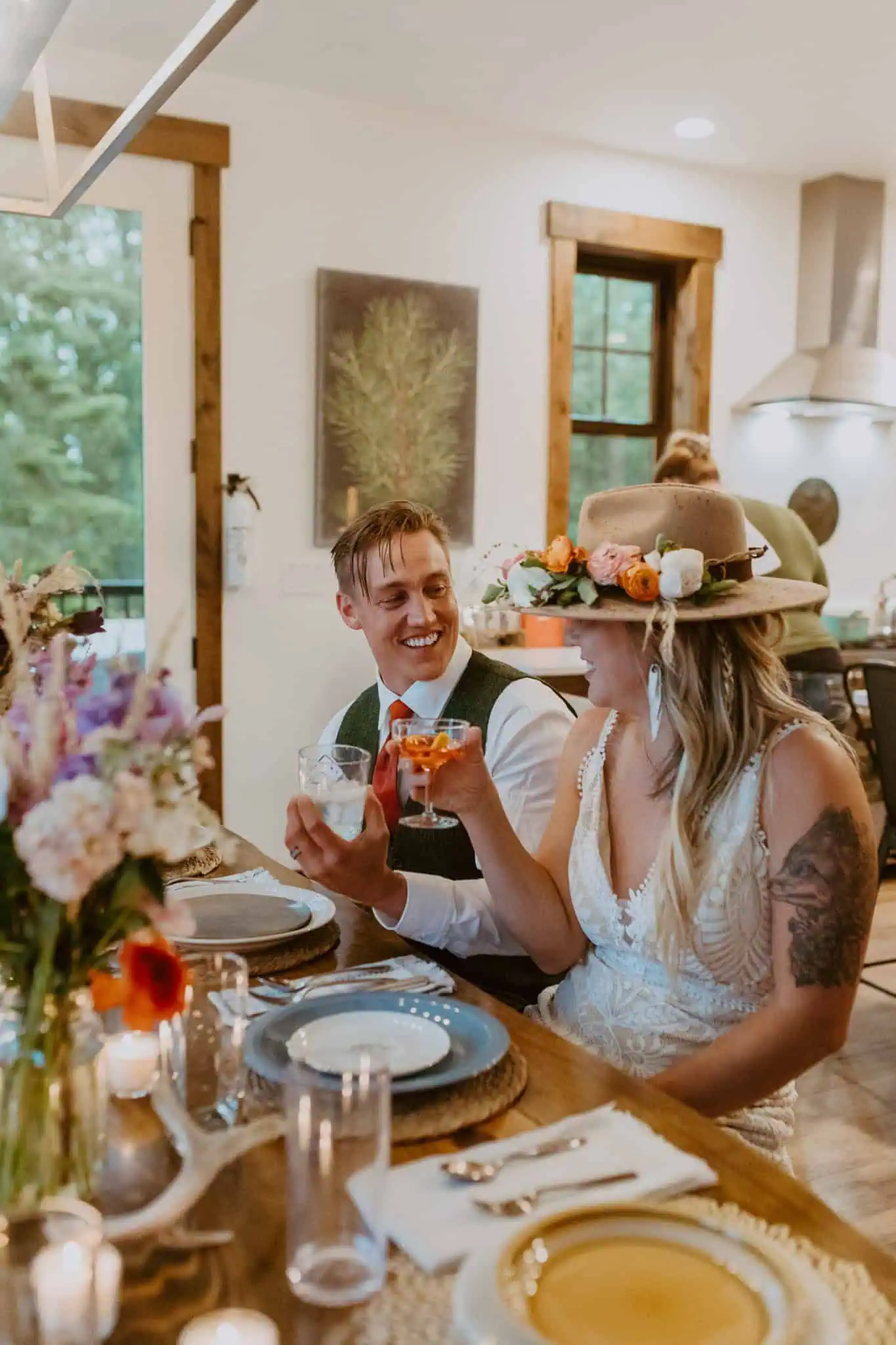 a couple cheering drinks for their wedding dinner
