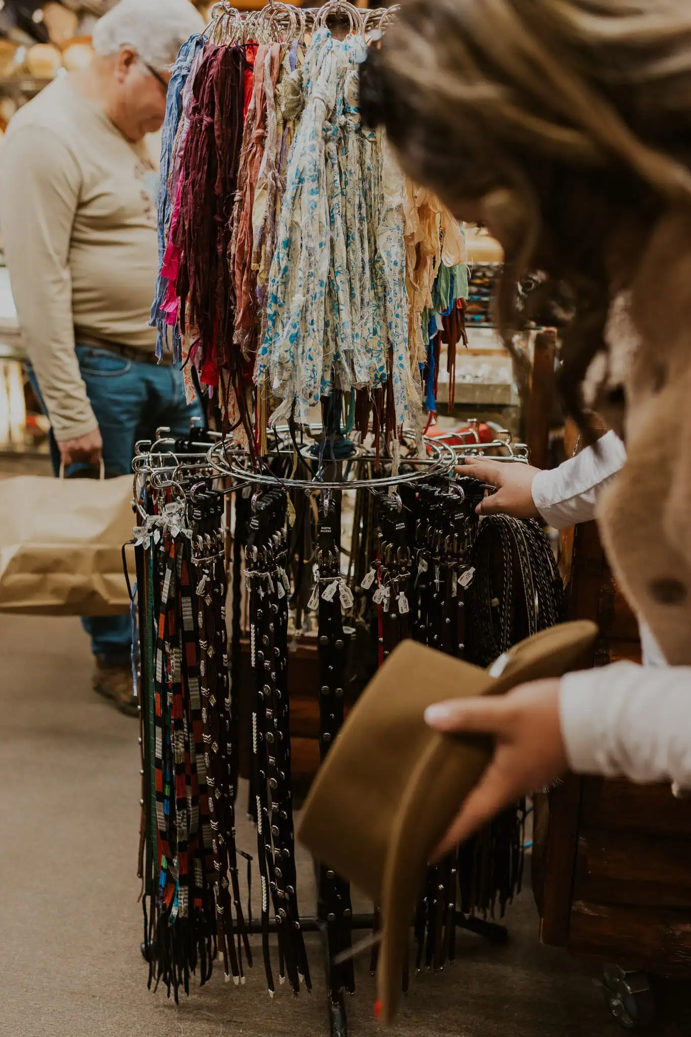 bride picking a hat out at beaver creek hat and leather