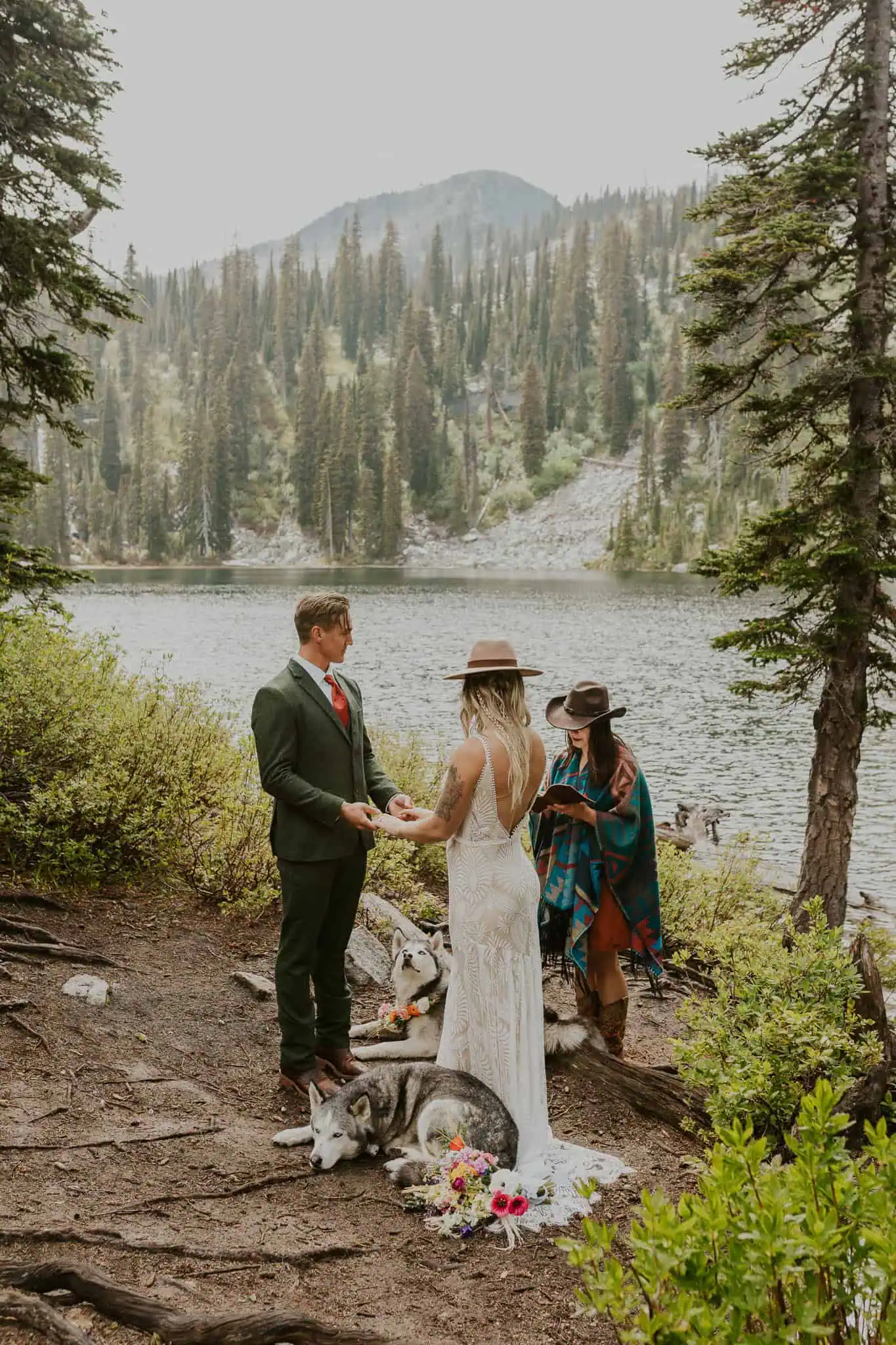 an elopement ceremony with dogs in the mountains with an alpine lake