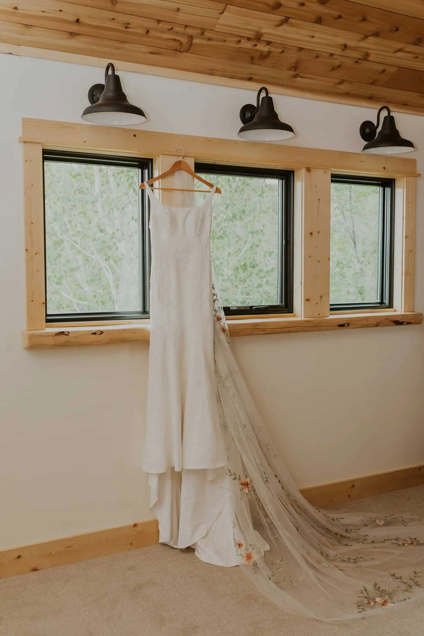 wedding dresss hanging on a window
