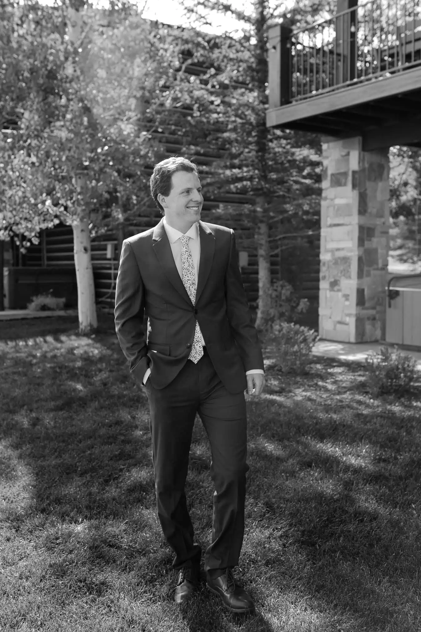 groom portraits by a cabin