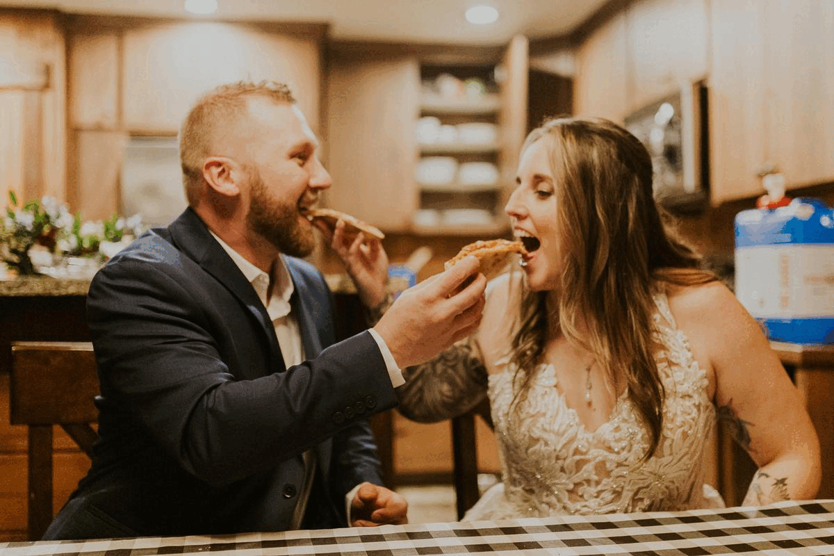 bride and groom feeding each other pizza gif