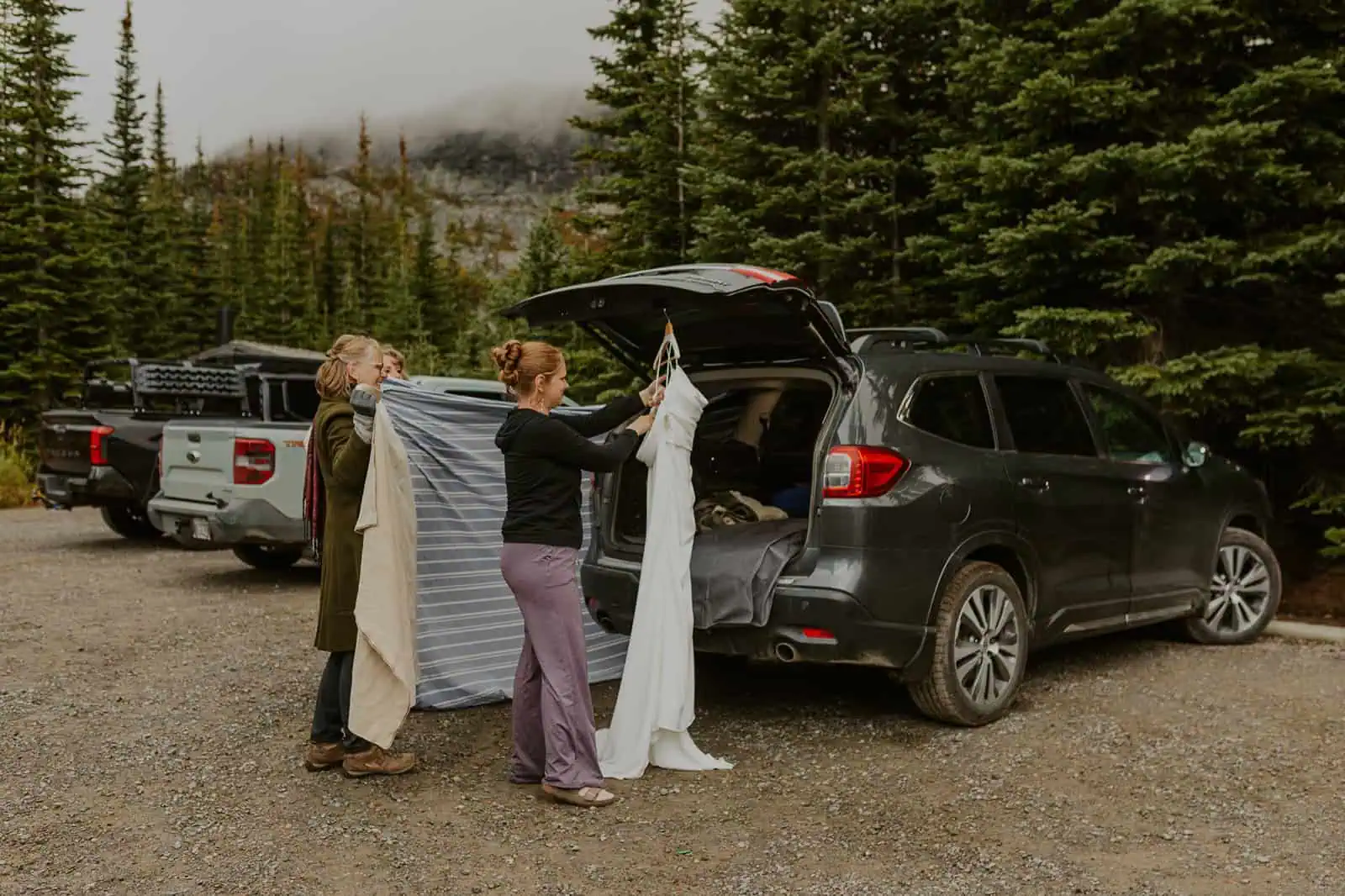 wedding dress hanging from car trunk