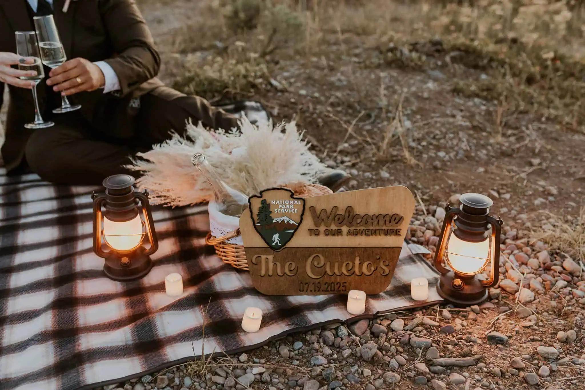 an elopement picnic at blue hour with champagne and lanterns
