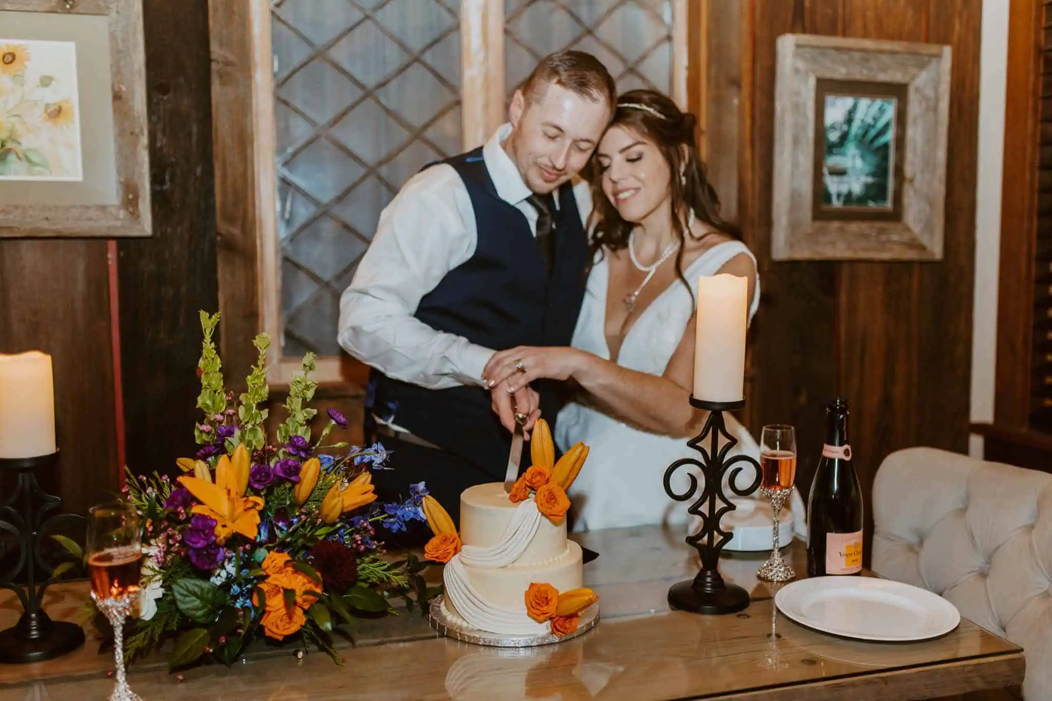 a couple cutting a cake indoors