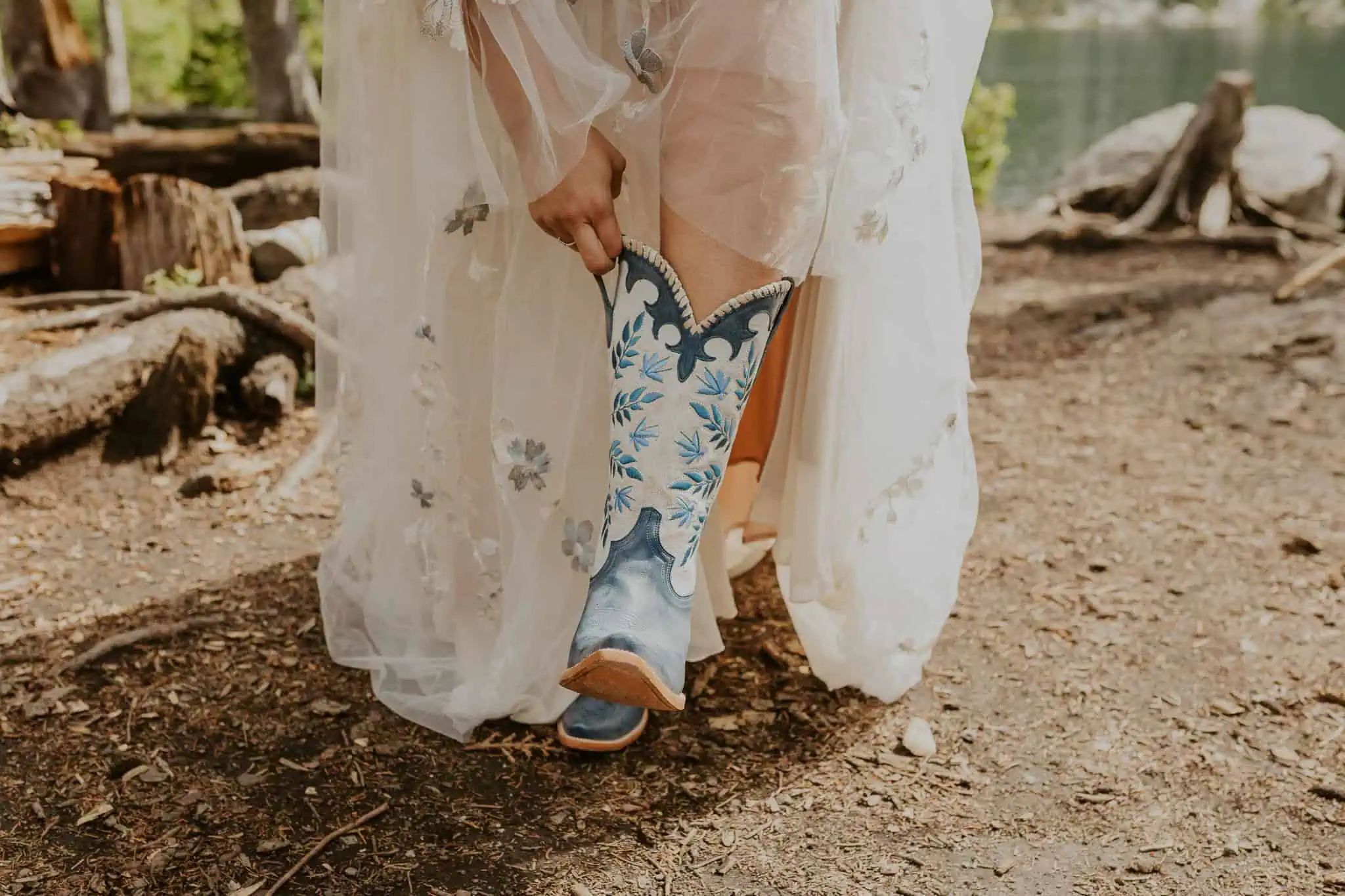 bride putting on blue cowgirl boots
