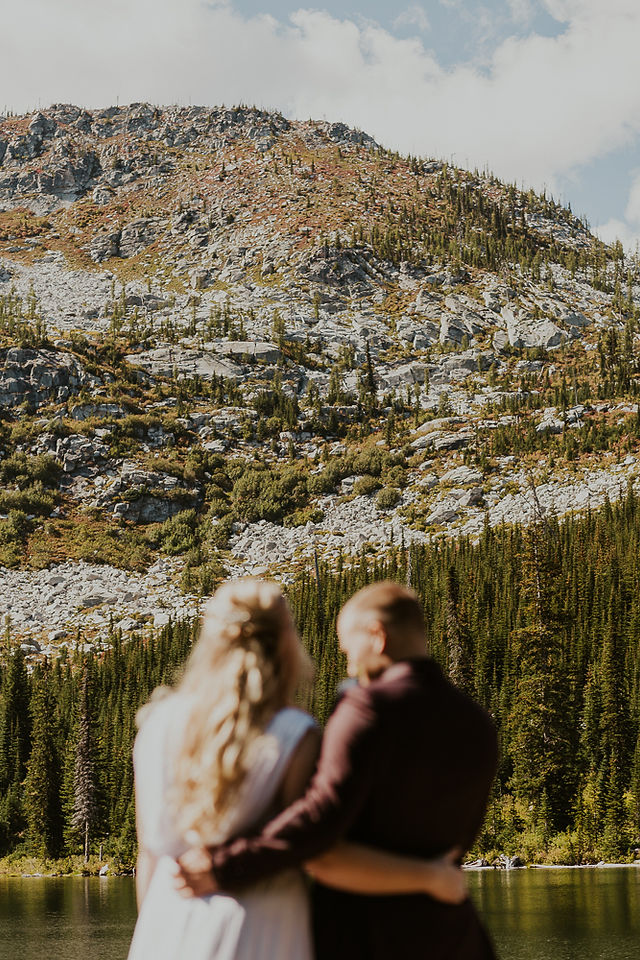 bride and groom at alpine lake in the selkirk mountains