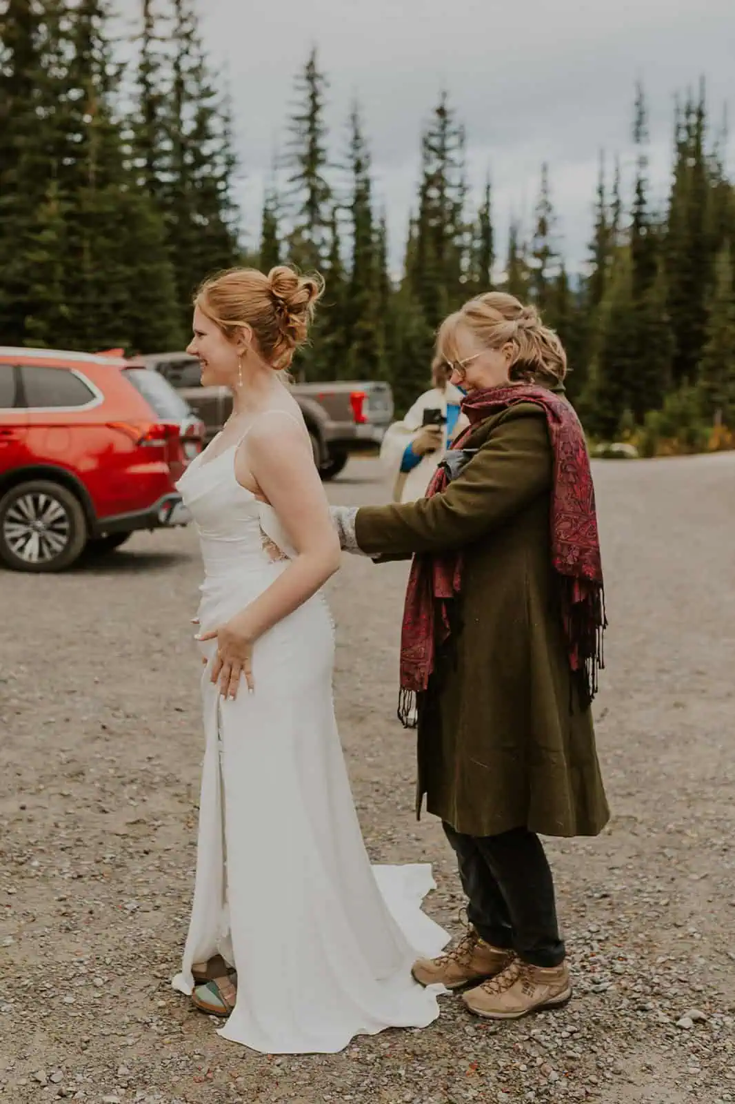 bride getting dressed in the mountains