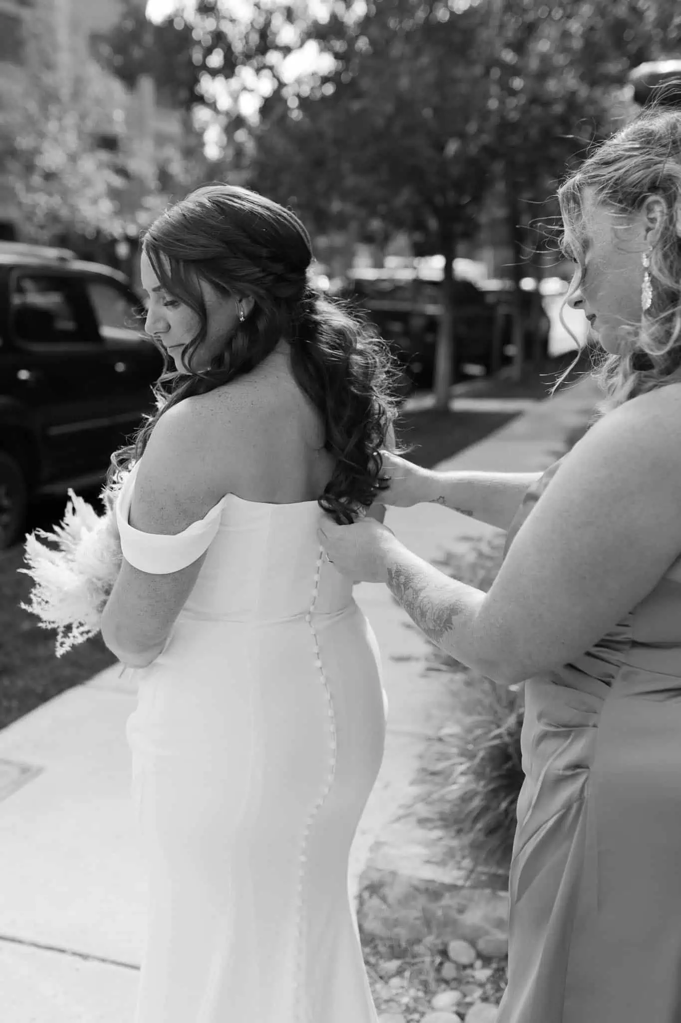 bride getting her dress zipped up