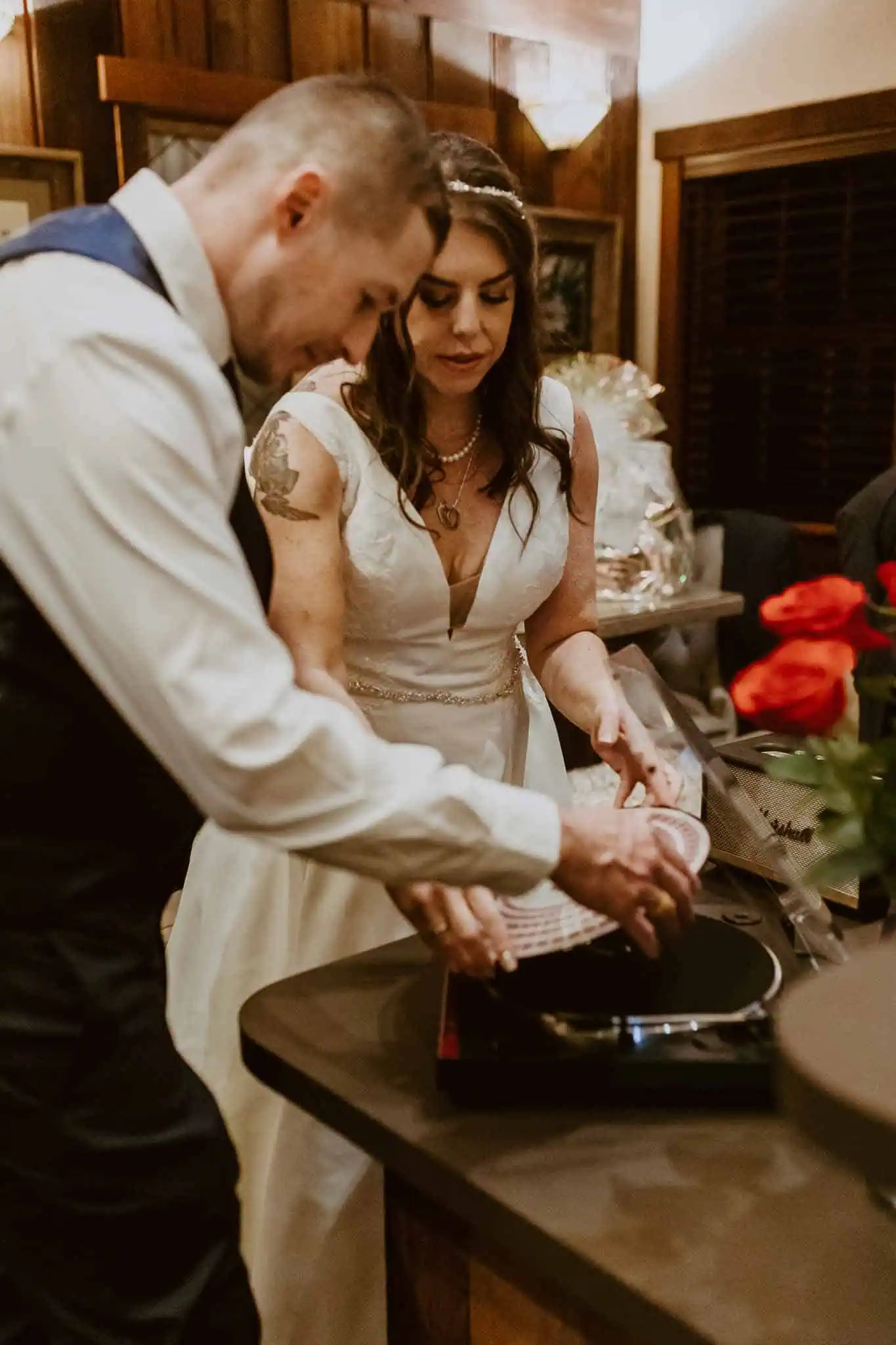 bride and groom putting on a record