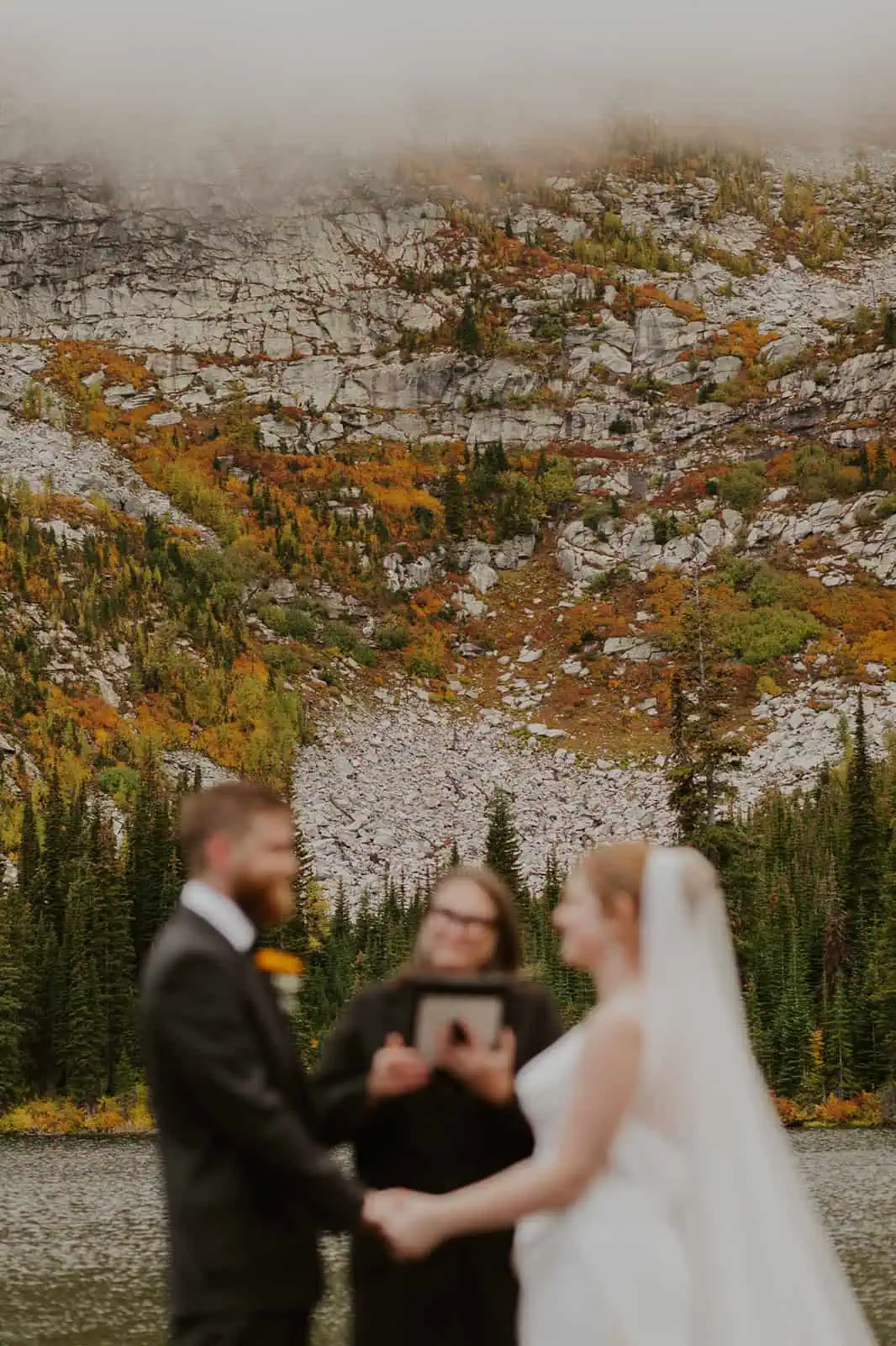 sunrise elopement ceremony at an alpine lake in the fall