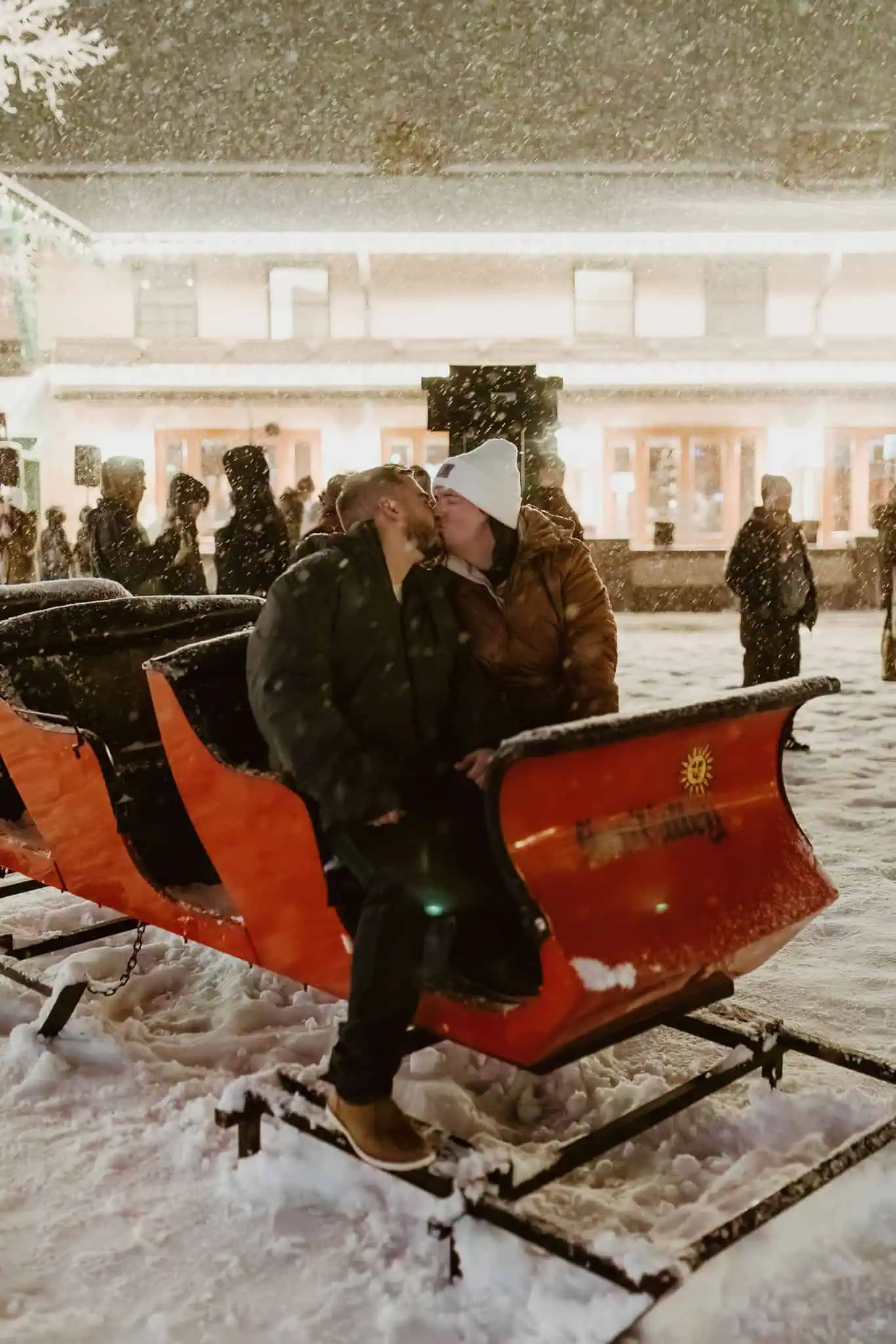 a couple kissing in a red sleigh