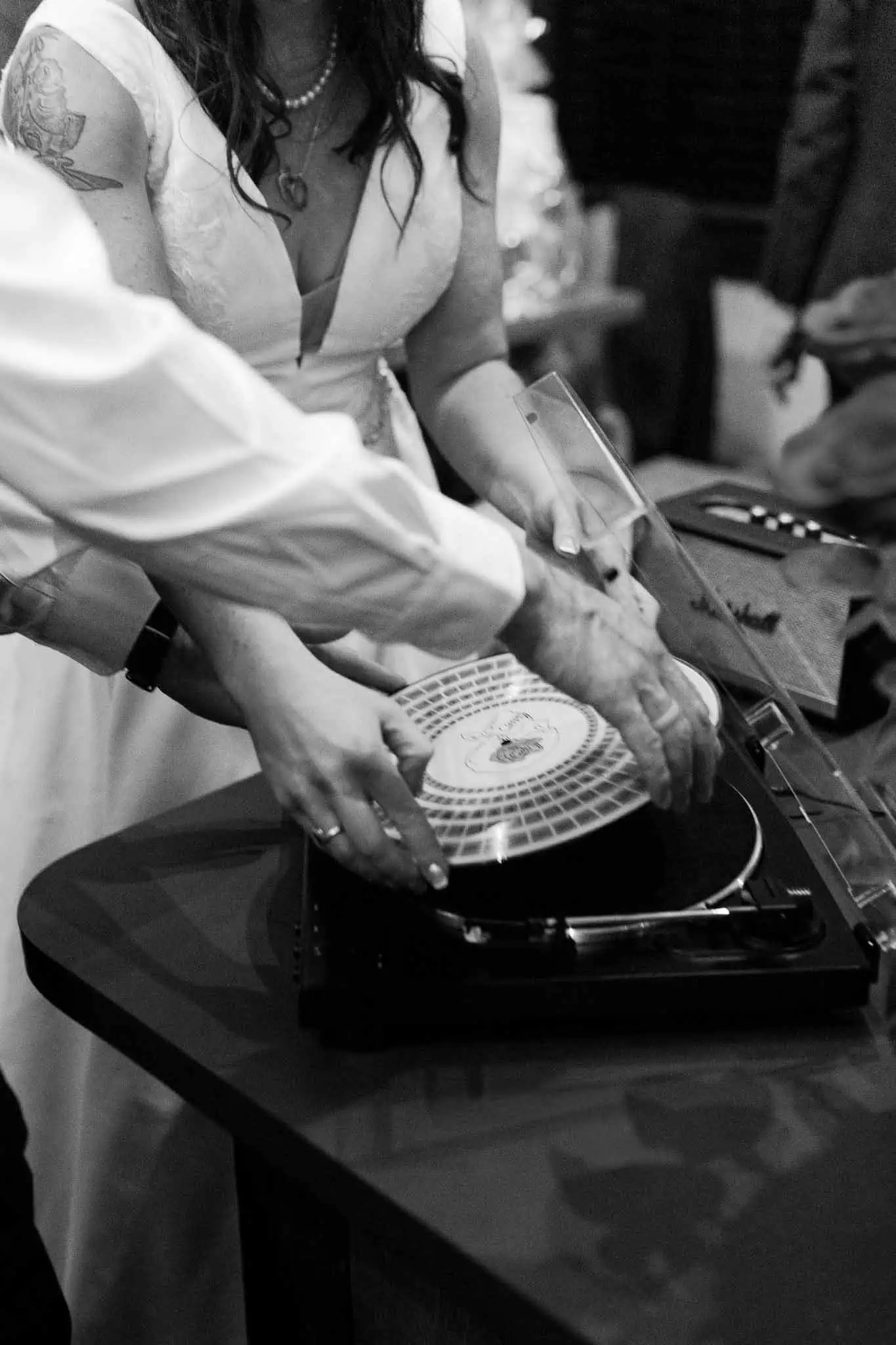 bride and groom putting on a record