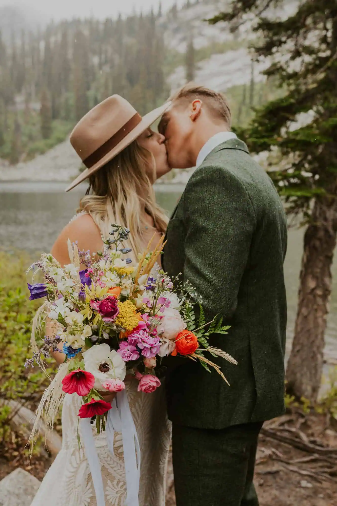 an  eloping couple kissing in the rain