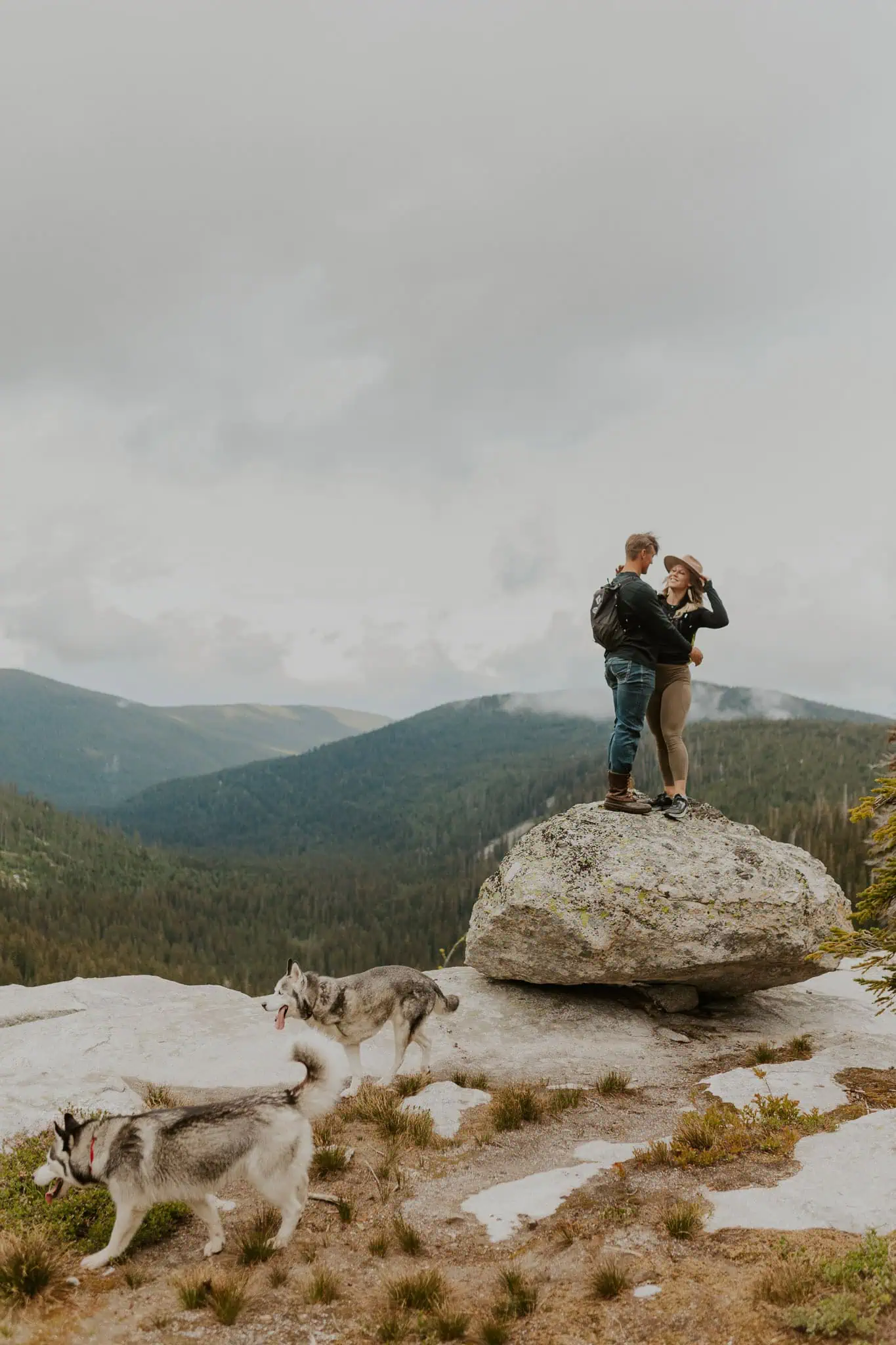 a couple standing on a rock
