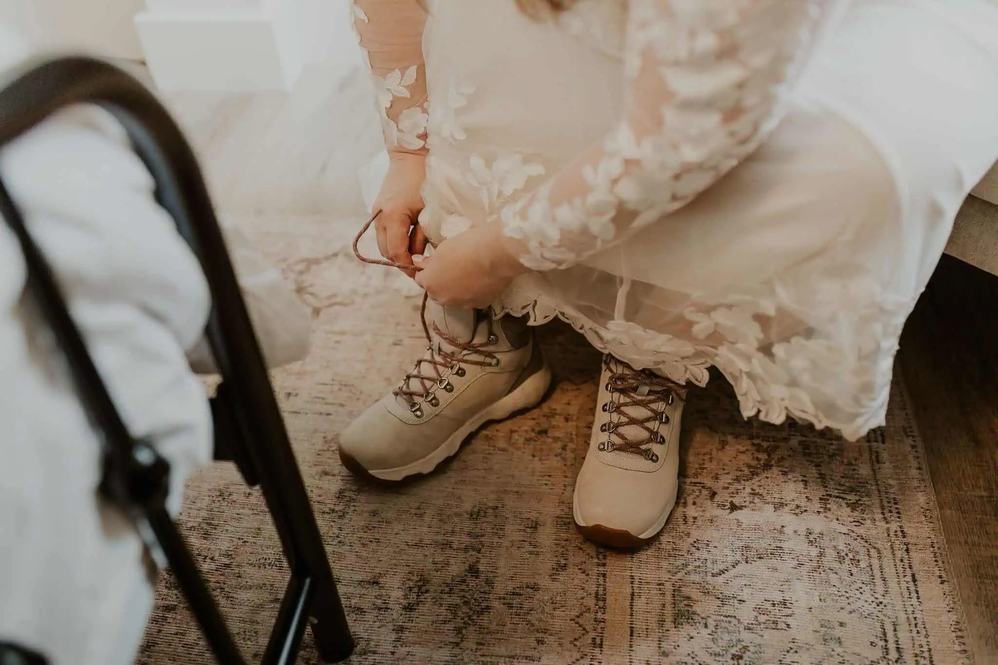 a bride putting on white columbia hiking boots