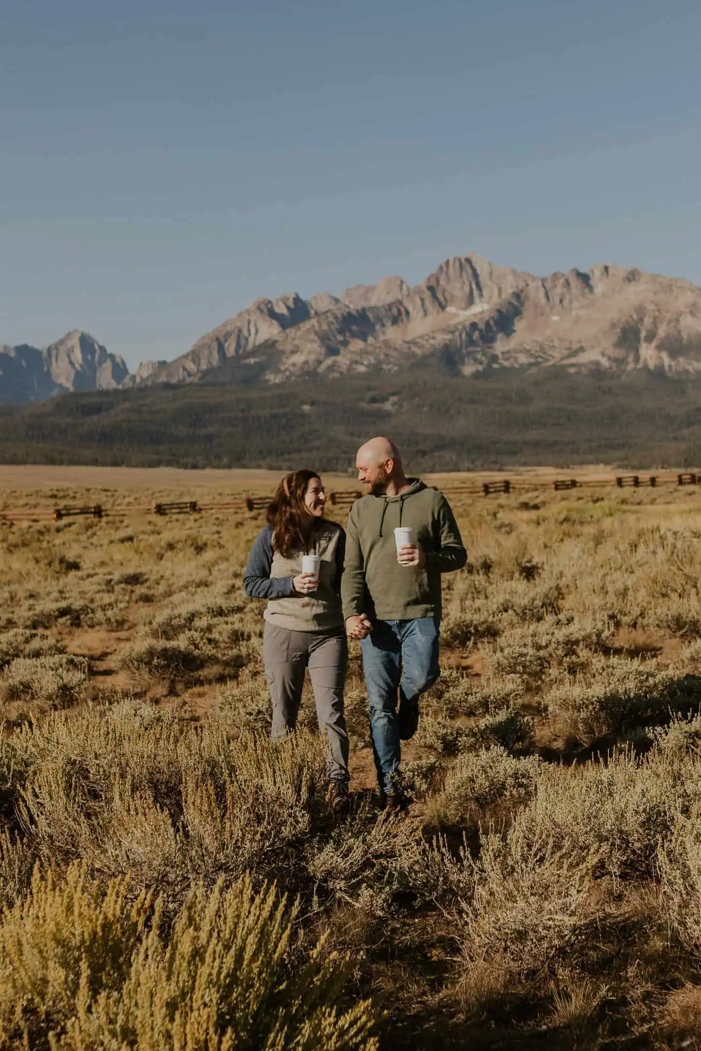 couple walking and enjoying coffees in pioneer park